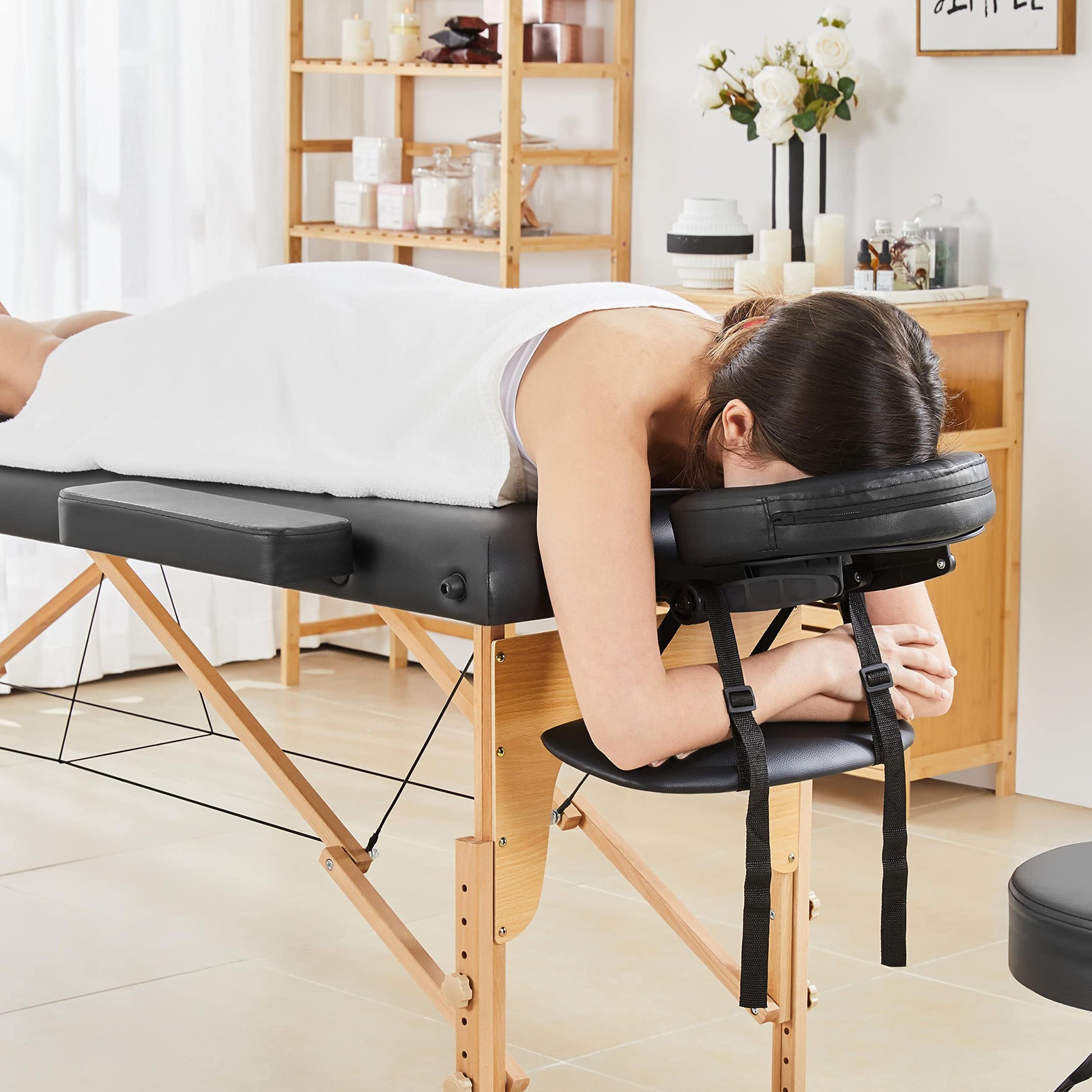 Portable Yaheetech Massage Table with Adjustable Headrest in use.